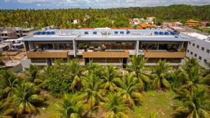 an aerial view of a building with palm trees at Kanui Garden Milagres in São Miguel dos Milagres