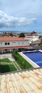 a view from the roof of a building with a swimming pool at Pousada Jardins - Mar Grande in Vera Cruz de Itaparica