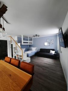 a living room with a couch and a staircase at Petit Bagage 2019 Neueröffnung in Sankt Augustin