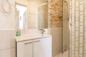 bagno bianco con lavandino e doccia di Arena view from the Apartment a Pola (Pula)