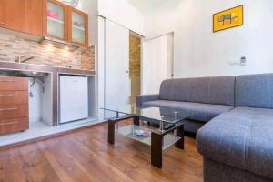 a living room with a couch and a glass table at Arena view from the Apartment in Pula