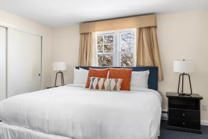 a bedroom with a large white bed with two lamps at The Beverly in Beverly