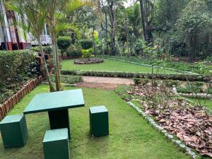 a bench sitting in a garden with a park at Eeshani Guest Inn in Ella