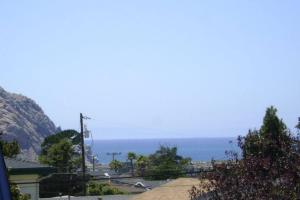 a view of the ocean from a house at Suite Breeze Beach Vacation Rental - one bedroom apartment. in Morro Bay