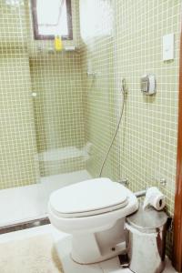 a bathroom with a toilet and a shower at Ed. Golden palace in Guarapari