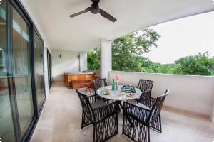 a patio with a table and chairs and a piano at Luxury Condo between 5th Avenue and the Beach in Playa del Carmen