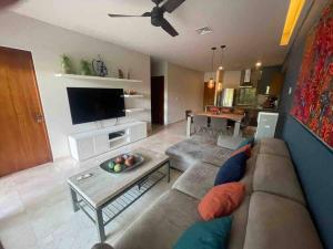 a living room with a couch and a table at Luxury Condo between 5th Avenue and the Beach in Playa del Carmen