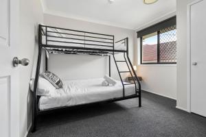 a bedroom with a bunk bed and a window at Large seven bed house in Jesmond