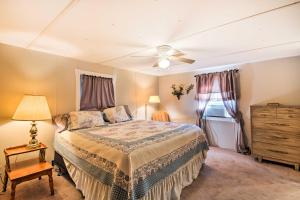 a bedroom with a bed and a ceiling fan at Waterfront House with Boat Slip on Lake Eufaula! in Canadian