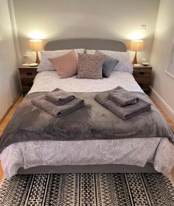 a bedroom with a bed with pillows on it at Peaceful Cottage for Two in Horsham in Horsham