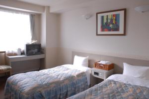 Postel nebo postele na pokoji v ubytování Hotel Hinodeya