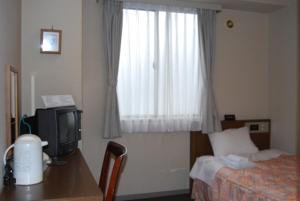 Postel nebo postele na pokoji v ubytování Hotel Hinodeya