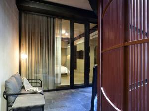 a room with glass doors and a bench in a room at Volga in Mexico City