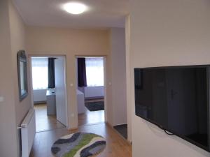 a living room with a large flat screen tv at Alfa apartman in Sárvár