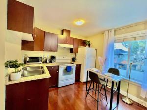 a kitchen with a sink and a table with chairs at The Royal Suite in Surrey