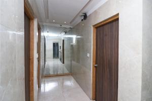 a hallway with a wooden door in a building at Hotel Hiland International Near Acropolis Mall in Jādabpur