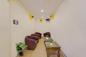 a room with chairs and a table in a room at Townhouse Fantasea Hotels Near OMR in Chennai +38 photos