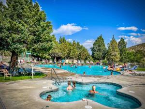 a group of people in the swimming pools at a resort at HomeAway Vacation Rental - Eagle Crest in Redmond