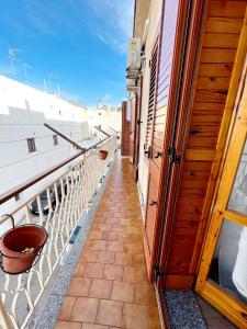 a balcony with a door and a view of the ocean at Il Girasole in Ostuni