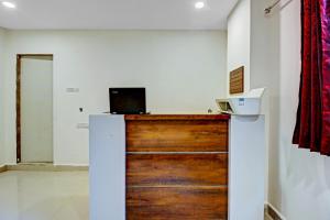a room with a wooden door with a laptop on top at Ab7 Residency Near Miraj Cinemas - Shalini Shivani in Hyderabad