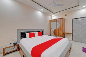 a bedroom with a large bed with red pillows at OYO The Castle Home Stay Inn in Jaipur