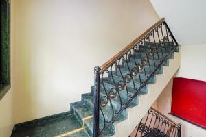 a staircase in a house with a green and gold railing at Hotel Sapna Near Anand Nagar (Dahisar) Metro Station in Mire