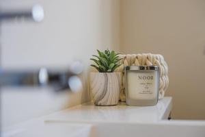 a candle sitting on a counter next to a potted plant at Stylish New Bungalow - Ideal for up to 10 in Welney