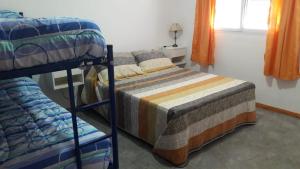 a bedroom with two bunk beds and a window at Antú in Carhué