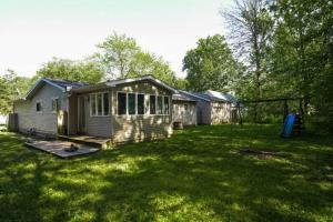 a small house in a grassy yard with a playground at "Mentor Place" a 4 bedroom home in the heart of a lake community min away from lot's activities in Mentor