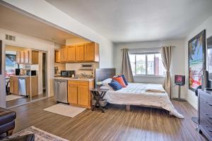a bedroom with a bed and a kitchen at Newport Beach Vacation Rental - Short Walk to Pier in Newport Beach