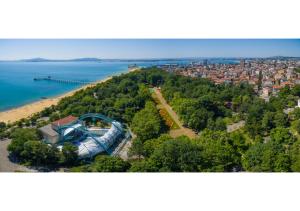 a large building on a hill next to a beach at Luxury apartment on the first line to the sea in Burgas City