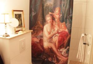 a shower curtain in a bathroom with a painting at Refugium der Liebe in Berlin in Berlin