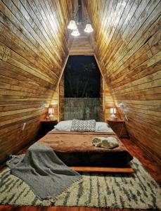 a bedroom with a bed in a wooden wall at Airport Traveler's home. in Alajuela City