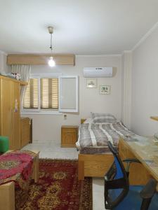 a bedroom with a bed and a table in it at القاهره in Cairo