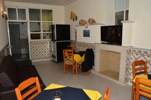 a living room with a tv and a fireplace at Residencial A Doca in Faro