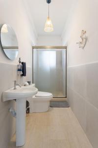 a bathroom with a toilet and a sink and a shower at Beach front Blue Summer Apartment Costa Del Sol in El Zapote