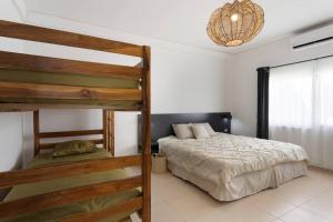 a bedroom with two bunk beds and a window at Beach front Blue Summer Apartment Costa Del Sol in El Zapote
