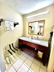 a bathroom with a sink and a mirror at Rodeway Inn Expo Center in Spartanburg