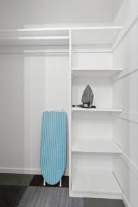a blue suitcase sitting in a white closet at Stylish Green & Gold 2BR / 1Bath Apartment in SFO in South San Francisco