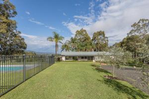 a house with a fence and a yard at Hunter Gleann Pty Ltd in Pokolbin