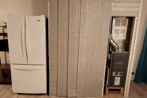 a white refrigerator sitting in a kitchen next to a wall at Newly renovated home with WIFI and ROKU TV in Brimley