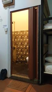a door to a bathroom with a toilet in a room at Happy Garden in Kampong Tenompok