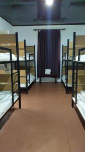 three bunk beds in a room with a window at Happy Garden in Kampong Tenompok