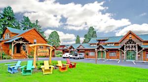 a playground in front of a log building at Finger Lakes Lodging in Skaneateles