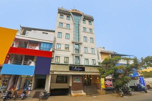 a building on a street with motorcycles parked in front of it at Collection O Mgr Inn in Puducherry