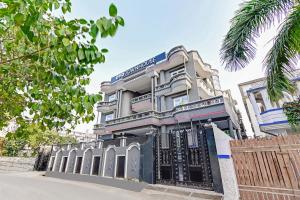 a building with a fence in front of it at Super Townhouse 096 Lohia Park in Vibhuti Khand