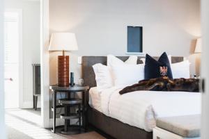 a bedroom with a bed and a table with a lamp at Eichardt's Private Hotel in Queenstown