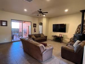 a living room with couches and a flat screen tv at Spacious Home in Page