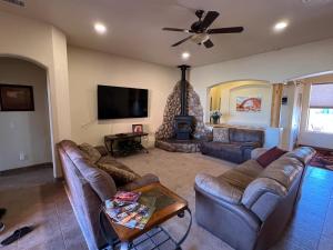 a living room with couches and a flat screen tv at Spacious Home in Page