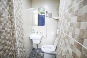 a bathroom with a toilet and a sink at Daegu Midtown Hostel in Daegu
